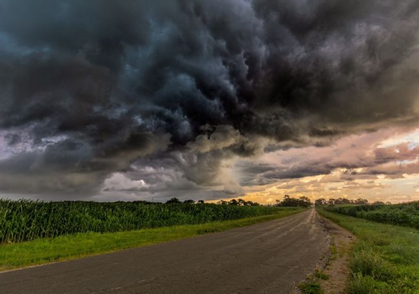 A storm building over a country road